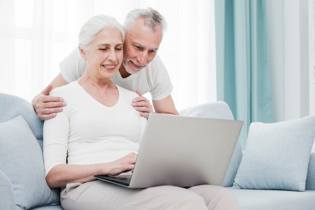 aposentadoria especial dentista casal de idosos olhando tela do notebook